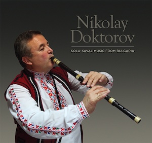 Image of Nikolay Doktorov playing the kaval while dressed in a traditional Bulgarian shirt and vest.